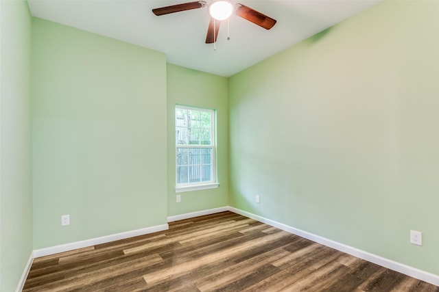 empty room featuring dark wood-type flooring and ceiling fan