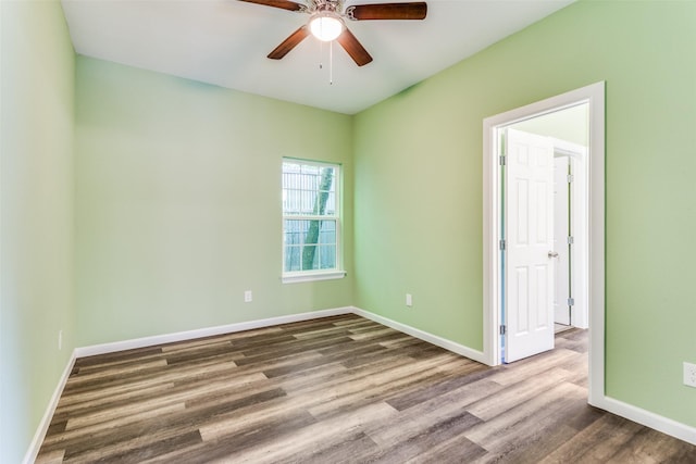 empty room with wood-type flooring and ceiling fan