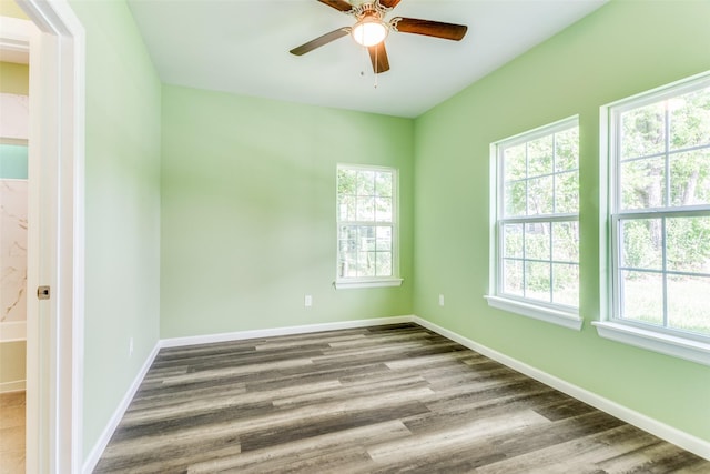 unfurnished room with hardwood / wood-style flooring and ceiling fan