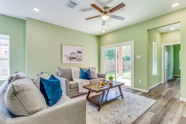 living room featuring hardwood / wood-style flooring and ceiling fan