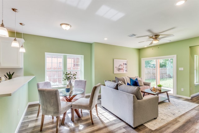 living room featuring wood-type flooring and ceiling fan