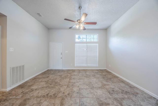 empty room featuring ceiling fan and a textured ceiling