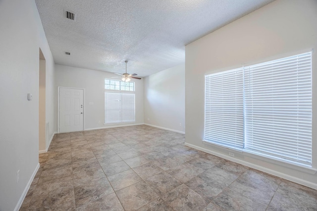 spare room featuring ceiling fan and a textured ceiling