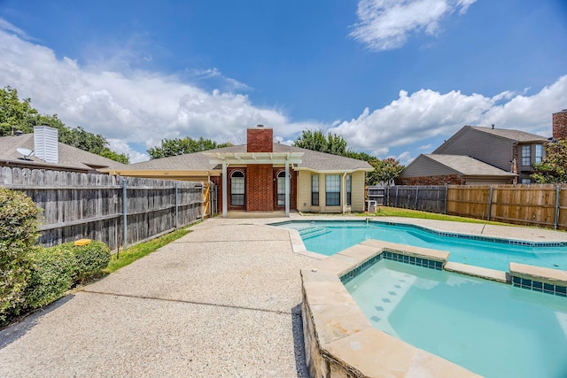 view of swimming pool featuring a patio area and an in ground hot tub