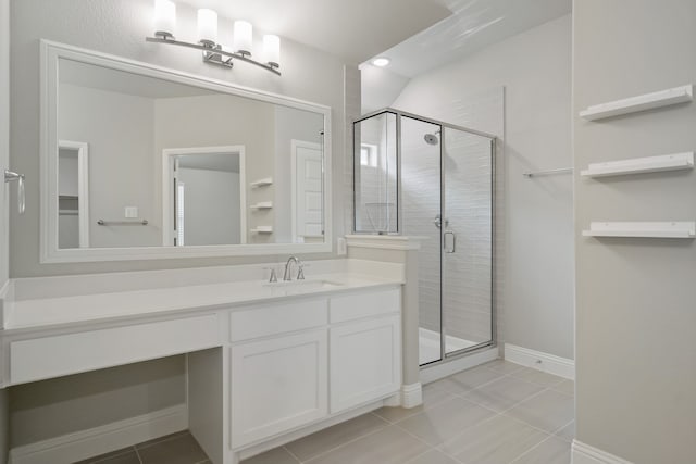 bathroom with tile patterned flooring, a shower with door, and vanity