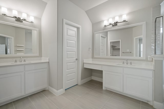 bathroom featuring lofted ceiling, vanity, tile patterned flooring, and an enclosed shower