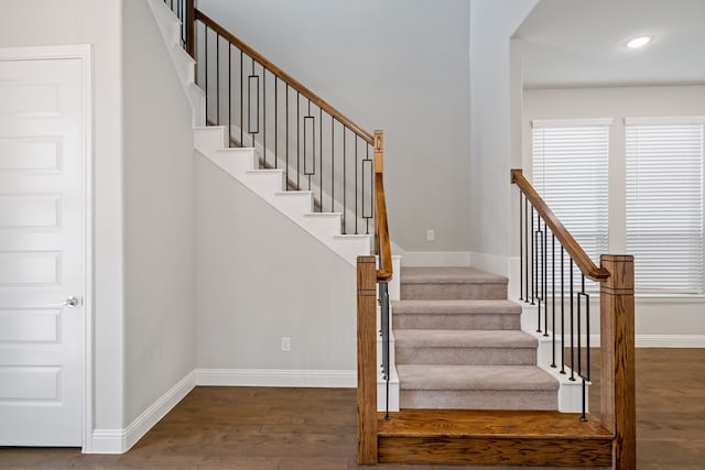 stairs featuring hardwood / wood-style floors