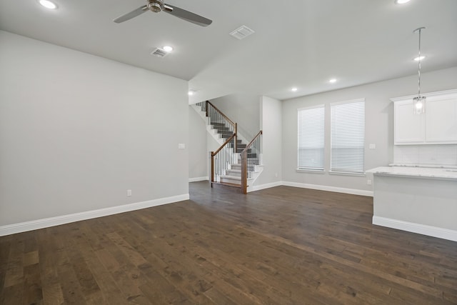 unfurnished living room with ceiling fan and dark hardwood / wood-style flooring