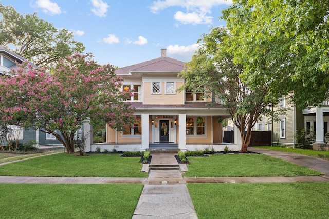 view of front facade with a front lawn and a porch