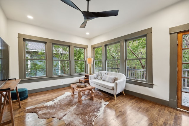 sunroom featuring ceiling fan