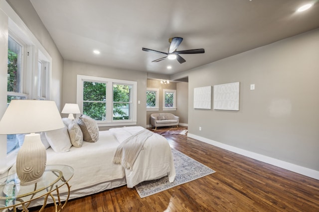 bedroom with dark hardwood / wood-style flooring and ceiling fan