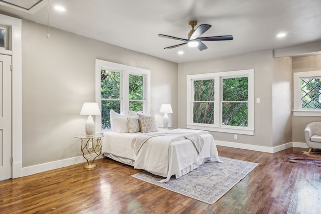 bedroom with dark hardwood / wood-style floors and ceiling fan