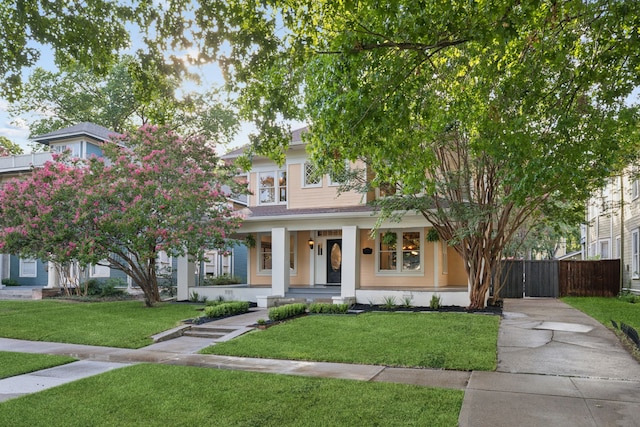 view of front of home featuring a porch and a front lawn