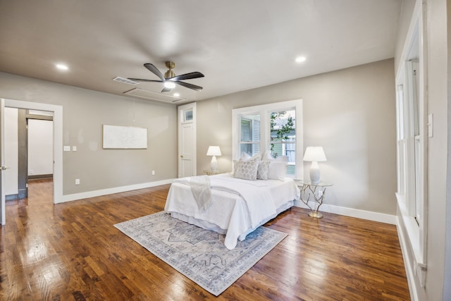 bedroom with dark hardwood / wood-style flooring and ceiling fan