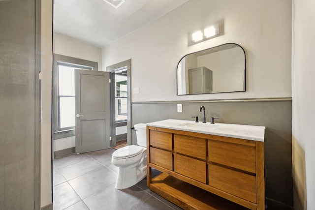 bathroom featuring vanity, toilet, and tile patterned flooring