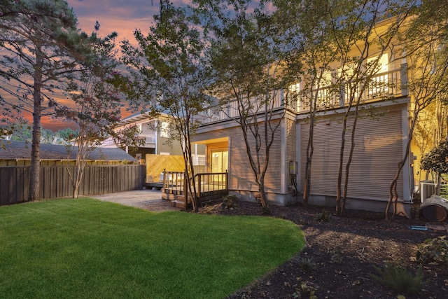 yard at dusk featuring cooling unit