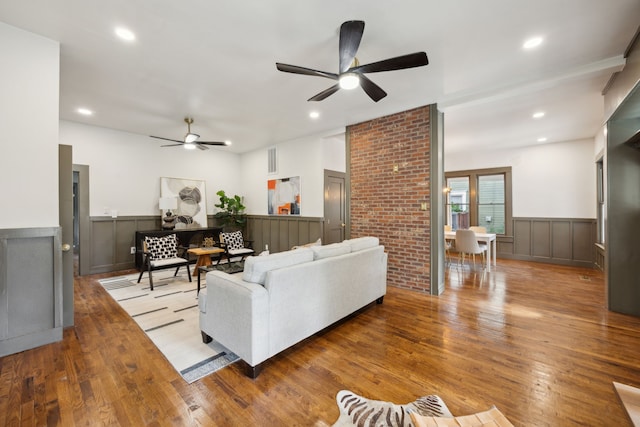 living room with ceiling fan and light wood-type flooring