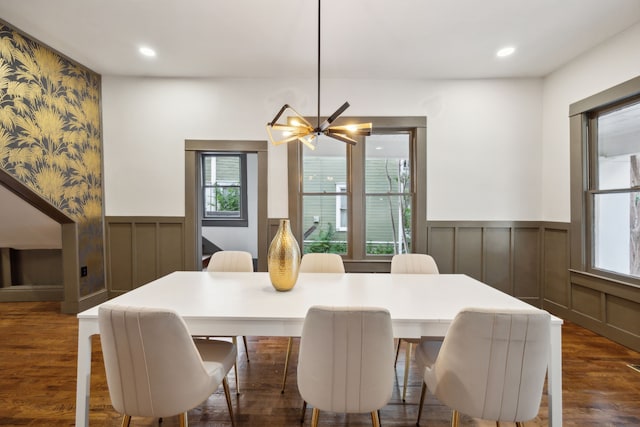 dining space with a chandelier and dark hardwood / wood-style flooring