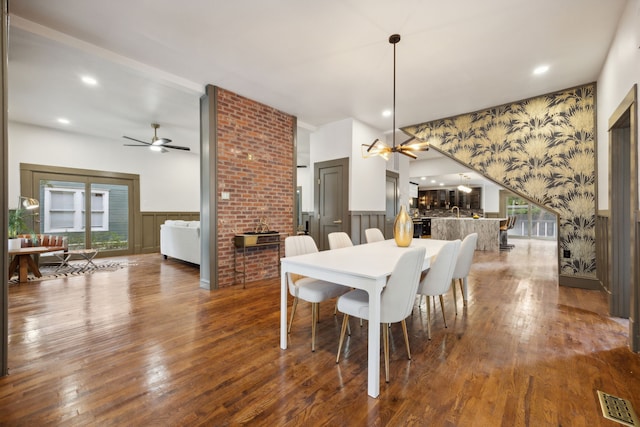 dining area with wood-type flooring and ceiling fan