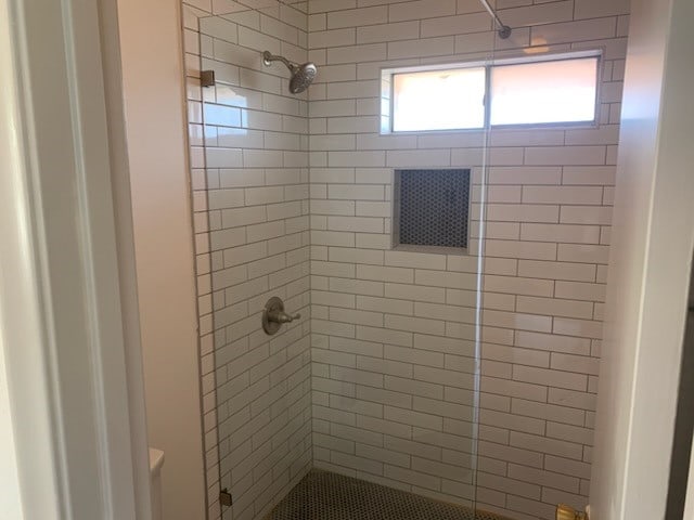 bathroom with tiled shower