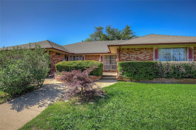 ranch-style house with a front lawn