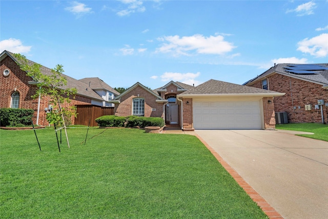 view of front facade featuring a front lawn, a garage, central AC unit, and solar panels