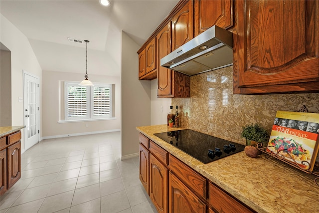 kitchen with black electric cooktop, tasteful backsplash, light stone counters, vaulted ceiling, and light tile patterned floors