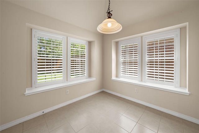 unfurnished room with light tile patterned flooring