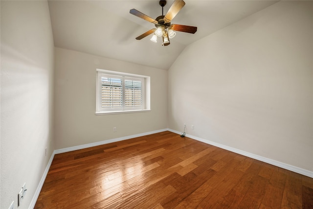 empty room featuring wood-type flooring, ceiling fan, and vaulted ceiling