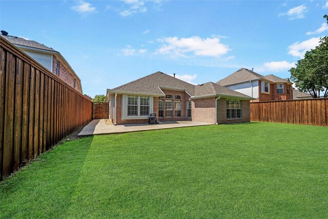 back of property featuring a patio and a yard