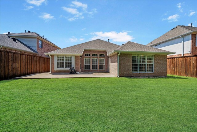 rear view of property with a patio and a yard