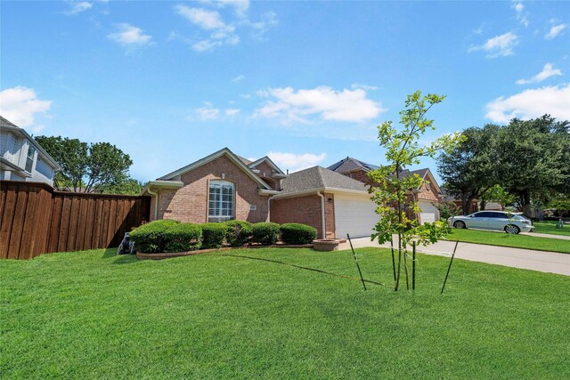 view of front facade featuring a garage and a front lawn