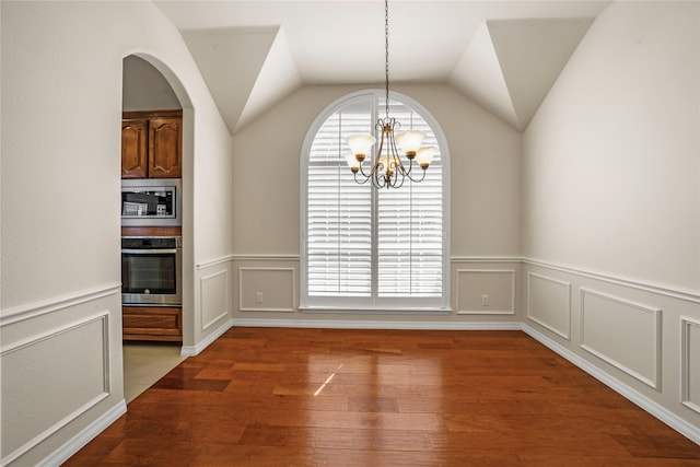 unfurnished dining area featuring an inviting chandelier, hardwood / wood-style flooring, and plenty of natural light