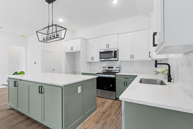 kitchen with white cabinetry, a kitchen island, stainless steel appliances, and green cabinetry