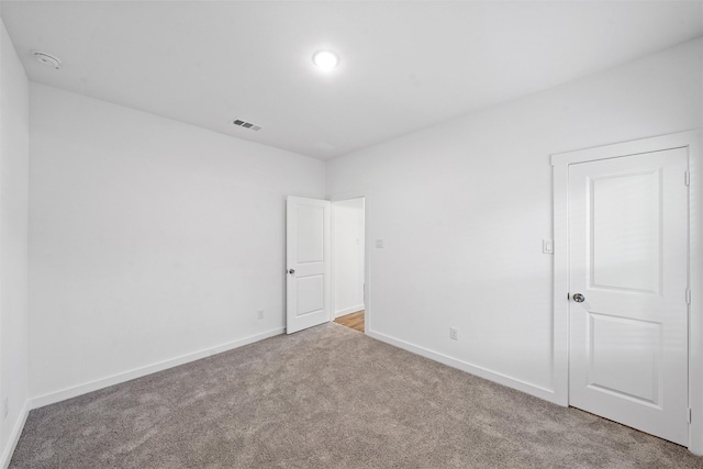 empty room featuring light colored carpet