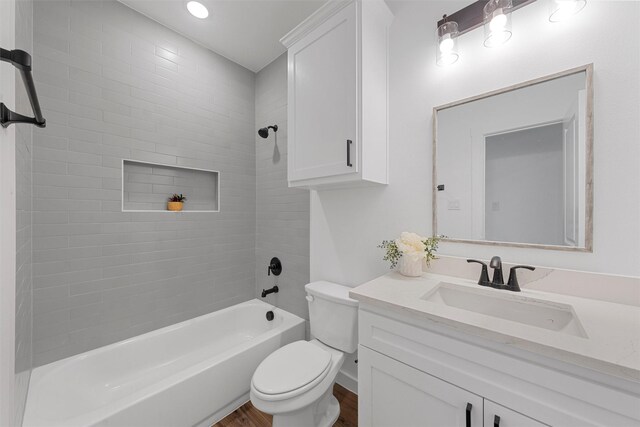 bathroom featuring vanity, tile walls, and a tub