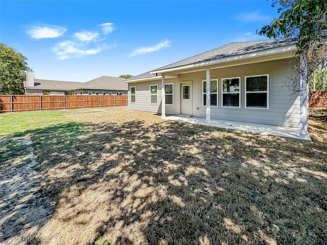 rear view of house with a lawn