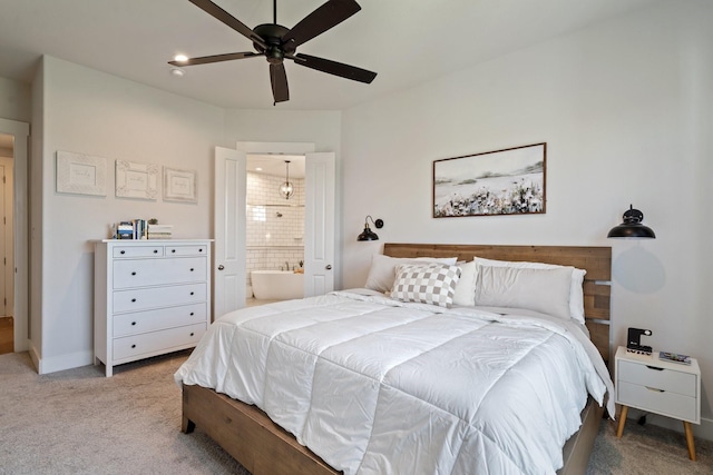 bedroom featuring connected bathroom, light colored carpet, and ceiling fan