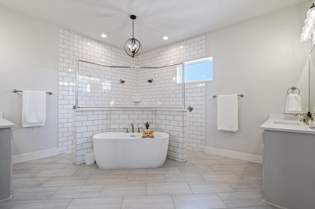 bathroom with vanity, a chandelier, and separate shower and tub