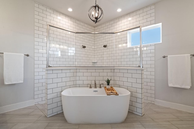 bathroom featuring shower with separate bathtub and tile walls