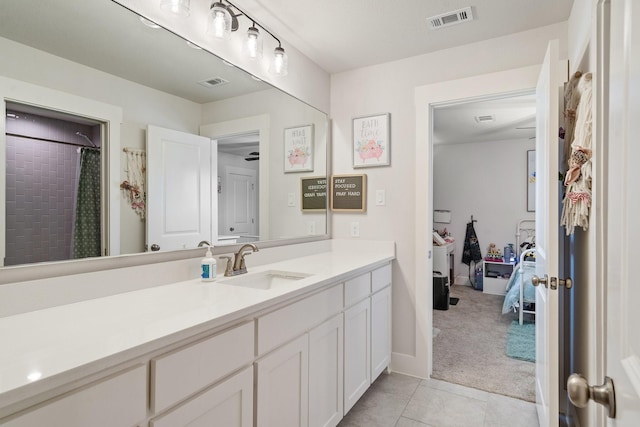 bathroom with tile patterned flooring, vanity, and a shower with curtain