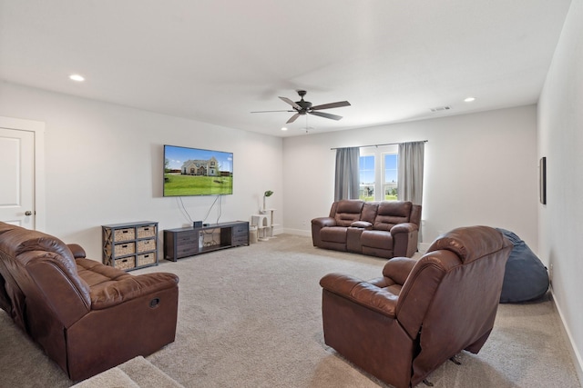 carpeted living room featuring ceiling fan