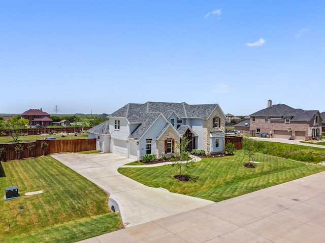 french country home with a garage and a front yard