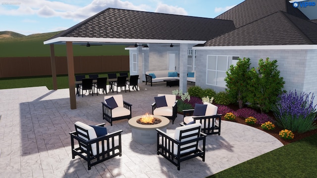 view of patio / terrace featuring ceiling fan and an outdoor living space with a fire pit