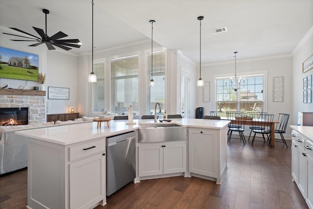 kitchen featuring white cabinetry, a kitchen island with sink, and stainless steel dishwasher