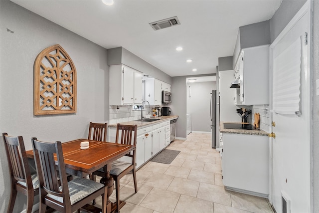 tiled dining area featuring sink