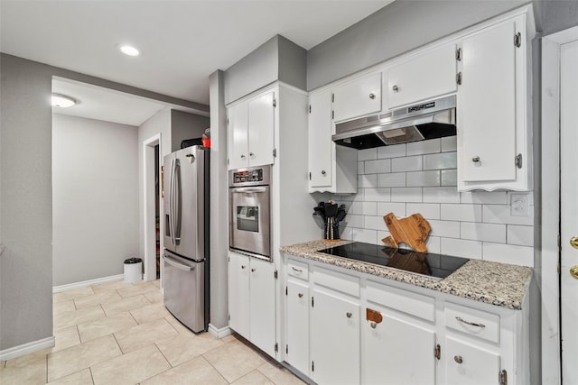 kitchen featuring light tile patterned floors, white cabinets, stainless steel appliances, light stone countertops, and decorative backsplash