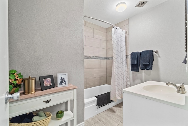 bathroom featuring shower / bath combination with curtain and vanity