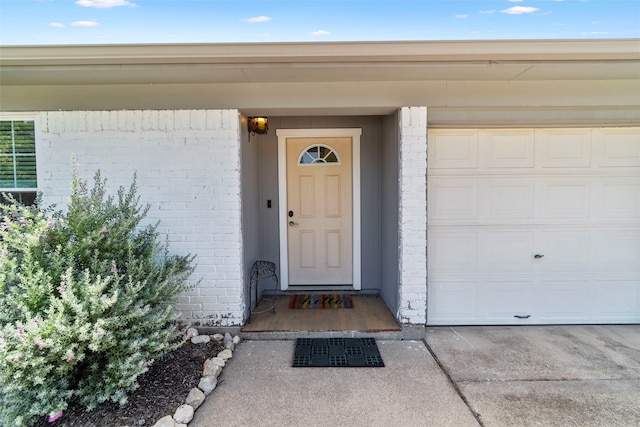 view of exterior entry with a garage