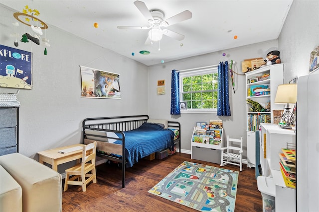 bedroom with dark hardwood / wood-style flooring and ceiling fan